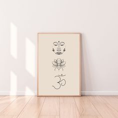 an art print on the wall above a wooden floor with a plant and buddha's face