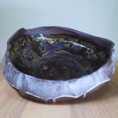 a bowl sitting on top of a wooden table