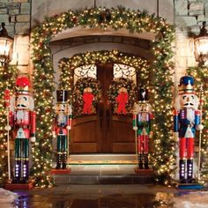 christmas decorations on the front door of a house decorated with lights and nutcrackers