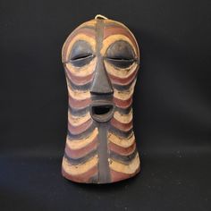 an african mask is displayed on a black background