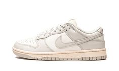 The Women’s Nike Dunk Low “Light Bone” is an inherently vintage, two-tone, white-and-grey colorway of the women’s sizing of the retro basketball shoe by Nike.  Inadvertently, the “Light Bone” mimics the look of many Dunk colorways found in Off-White and Nike’s “Lot 50” collection from August 2021.  Like “Lot 50,” the “Light Bone” features a simple, easy-to-wear color palette and subtle vintage-inspired details.  Here, Sail leather appears on the perforated toe, mid-panel, collar, and heel.  The Nike Dunk Low Light Bone, Dunk Low Light Bone, Womens Dunk Low, Nike X Travis Scott, Retro Basketball Shoes, Bone Shoes, Jordan 2, Nike Dunk High, Nike Shox