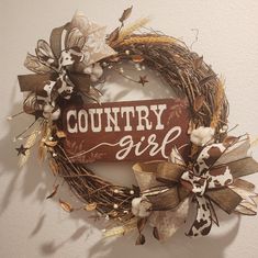 a wreath with the word country girl painted on it