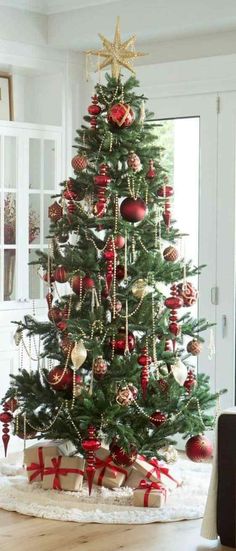 a decorated christmas tree with presents under it