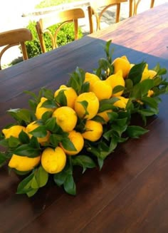 a bunch of lemons sitting on top of a wooden table