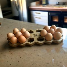 several eggs in an egg carton on a kitchen counter