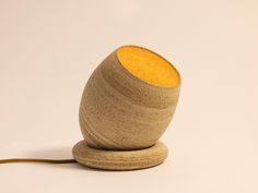 a wooden object with a yellow substance on it's top sitting on a white surface