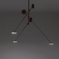 three lights are hanging from the ceiling in a room with white walls and flooring