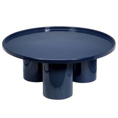 an oval blue table with three black cups on the bottom and one round in the middle