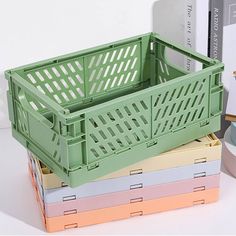 a stack of colorful boxes sitting next to each other on top of a white table