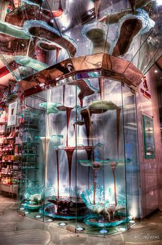 an artistic display in a store filled with lots of glass