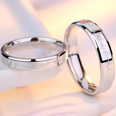 two wedding rings with engraved names on them