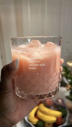 a person holding up a glass with some fruit in it and a quote on the side