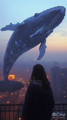 a woman standing in front of a window looking at a humpback whale