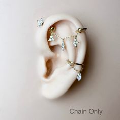 a pair of ear piercings on top of each other