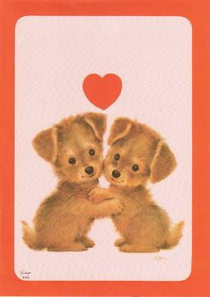 two little puppies sitting next to each other in front of a heart shaped card