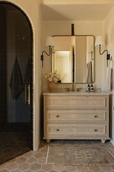 a bathroom with a sink and mirror in it