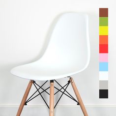 a white chair sitting in front of a wall with a rainbow strip on it's side