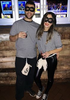 a man and woman dressed up as batman and catwoman posing for a photo together