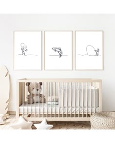 a baby's room with three framed pictures on the wall and a crib