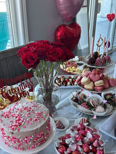 a table topped with lots of cakes and desserts