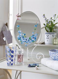 there is a mirror with blue flowers on it