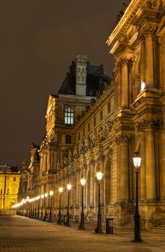 an old building is lit up at night