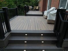 an outdoor deck with stairs and lights