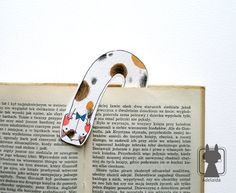 an open book with a paper cut out of the shape of a dog's head