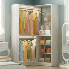 an open closet with clothes on hangers and a teddy bear in the corner next to it