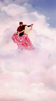 a man and woman are flying through the clouds