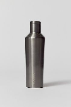 a stainless steel flask bottle is shown on a white background with the lid down