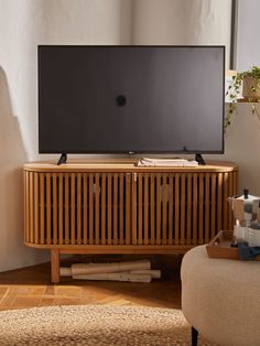 a flat screen tv sitting on top of a wooden cabinet