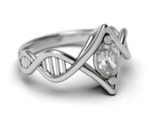 a white gold ring with a diamond in the center and an intertwined band around it