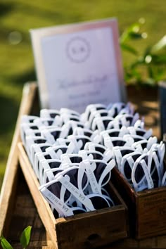 several boxes filled with chocolates sitting on top of a wooden table in the grass