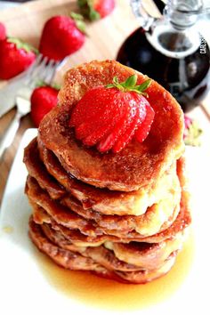 a stack of pancakes with strawberries on top