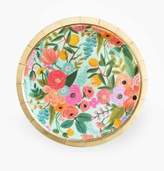 a colorful flowered tray with gold rim