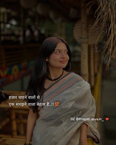 a woman with long hair wearing a white sari