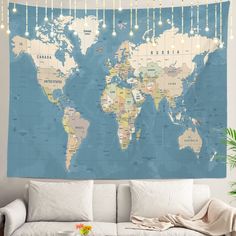 a living room with a white couch and a large blue world map on the wall