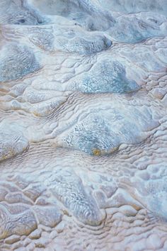 an aerial view of some rocks and water in the middle of nowhere, taken from above