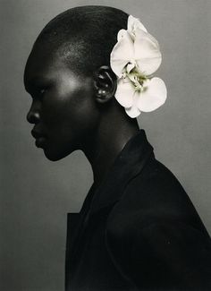 a magazine cover with a woman's face and flower in her hair