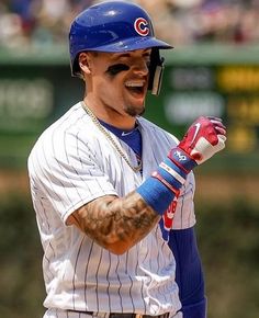 a baseball player is smiling and holding his glove