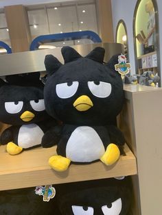 several stuffed animals sitting on top of a shelf