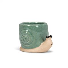 a ceramic cup with a snail on it