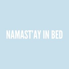 the words namast'ay in bed are white against a pale blue background