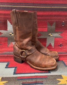 From Blackbird Vintage of Sedona, Arizona  This is a great pair of brown leather Vintage Frye Square toe harness Moto boots, Men's size 10.5,  circa 1990's.  They feature chunky long lasting Vibram lug soles! These great boots have a 1.75" heel and are 13" Tall.  They have a fantastic patina! They are in distressed and broken-in vintage condition. They are very well-made and have lots of life left! Condition Notes: -Worn, broken in, and distressed with scuffing, soiling, staining -Appears to be Brown Oiled Leather Boots For Western-themed Events, Rugged Brown Moto Boots With Leather Lining, Rugged Brown Moto Boots With Leather Sole, Rugged Brown Moto Boots For Biker Events, Western Brown Bridle Leather Boots, Vintage Brown Leather Moto Boots With Round Toe, Leather Moto Boots With Goodyear Welt For Western Events, Rugged Moto Boots With Oiled Leather And Round Toe, Brown Rugged Moto Boots With Buckle Closure