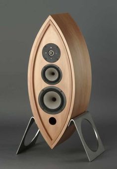 a wooden speaker with two speakers on it's side and an object in the background