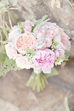 a bouquet of pink flowers sitting on top of a tree