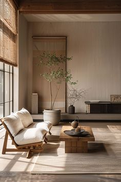 a living room filled with furniture and a plant in a vase on top of a coffee table