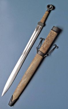 a knife with a wooden handle next to a sheathed knife on a blue background