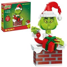 the grinch is sitting on top of a brick wall